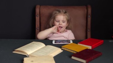 While preparing for school, the child studies at home. Distance learning, homework