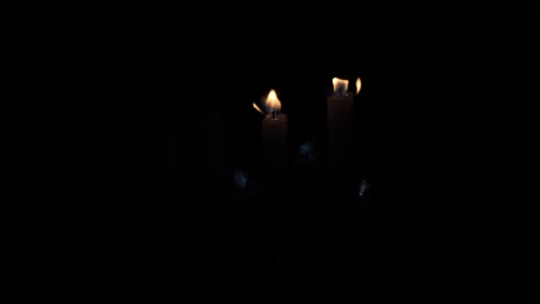 Few Candles Glow Dark Burning Candles Black Background Yellow Candles — Vídeo de stock
