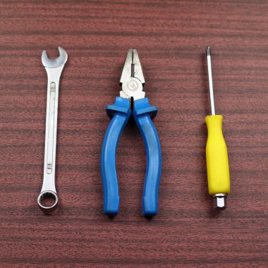 A set of tools. Equipment for work. Tools lie on a wooden background