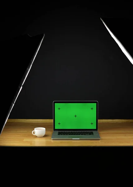 Computer on desktop, green screen. Chromatic key. Laptop for work, green scene.