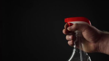 Water from a spray bottle on a black background. Small drops of water. Sprayer