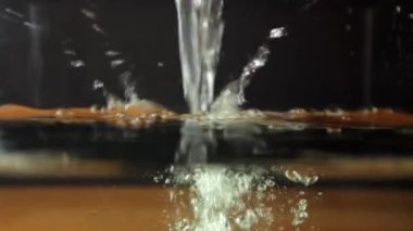 Water fills the aquarium. Pour plenty of water on top. Look through the glass as the water pours