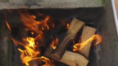 Barbecue in the yard. firewood, cooking. summer vacation near the barbecue. the fire is burning