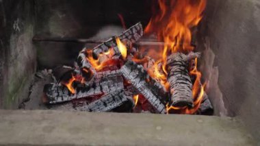 Barbecue in the yard. firewood, cooking. summer vacation near the barbecue. the fire is burning