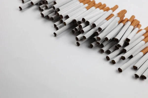 stock image Many cigarettes on a white background. A strong passion for smoking. Harmful to health. Smoking can be harmful to your health. It's a pity for the environment. Health problem, causes cancer. Cigarette