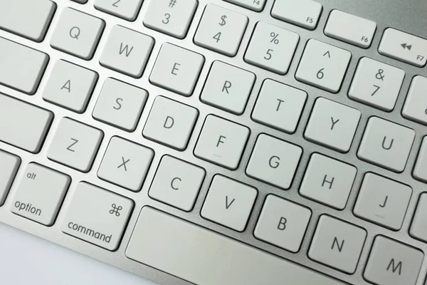 stock image Gray keyboard with white buttons. Wireless keyboard. Computer components. Text input device. Keyboard on a white background