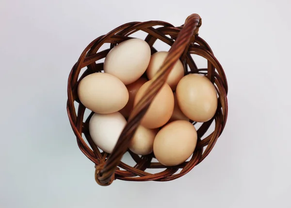 Easter eggs. Eggs on a white background. Chicken eggs in a basket. A basket on a white background for Easter