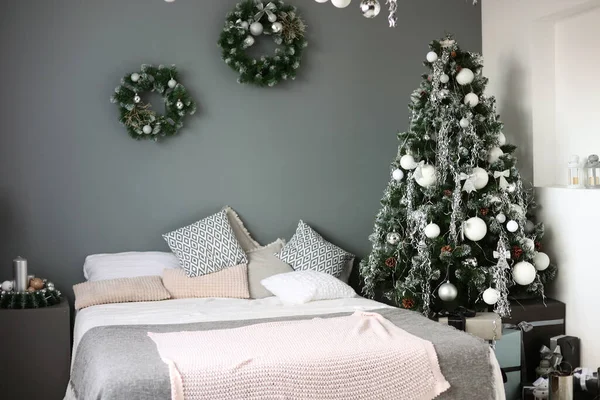 New Year\'s room, bed and Christmas tree. Christmas, winter decorations. Christmas toys, balls, holidays. Happy New Year