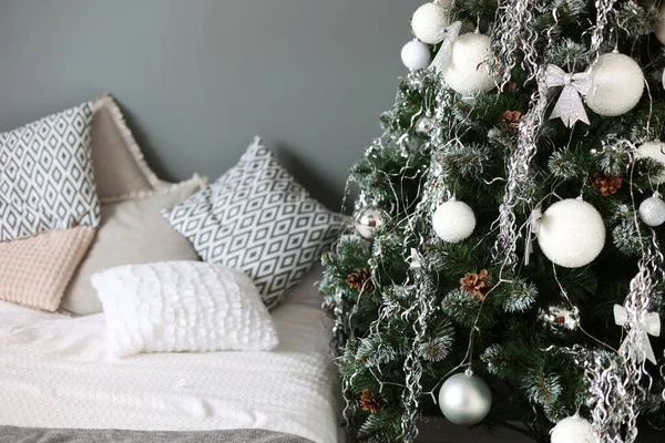 New Year\'s room, bed and Christmas tree. Christmas, winter decorations. Christmas toys, balls, holidays. Happy New Year
