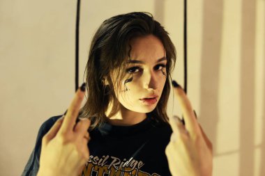 Gotik tarzda bir kız, yüzünde makyaj var. Siyahlı çekici esmer kadın. Genç bir kadın eski bir odada kameraya poz veriyor. Güzel model, dramatik sahne
