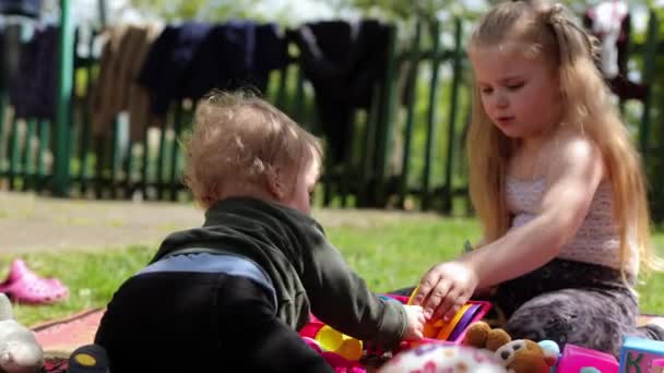 Little Blond Boy Playing His Sister Backyard Child Outdoors Beautiful — стокове відео