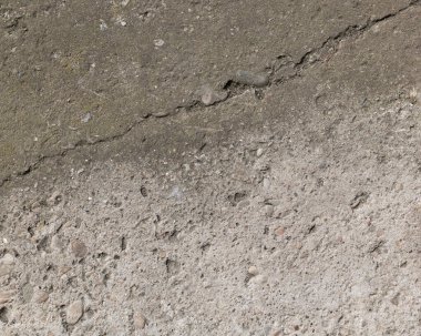 Harap olmuş beton yolun arka planı, gri beton, beton doku, yakın plan. Doğal fotoğraf. Eski beton levha