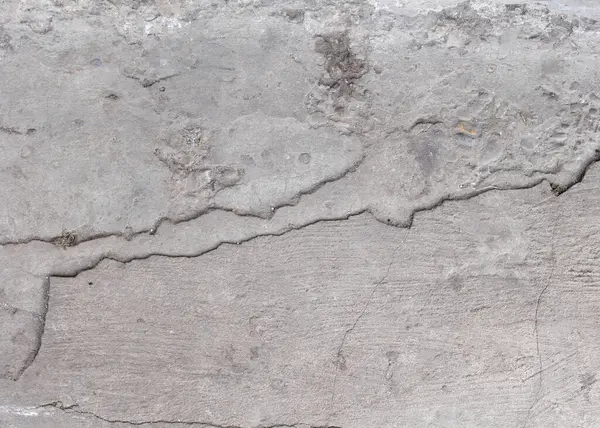 Harap olmuş beton yolun arka planı, gri beton, beton doku, yakın plan. Doğal fotoğraf. Eski beton levha