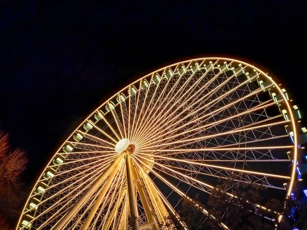 A giant ferris wheel in Florence at night 