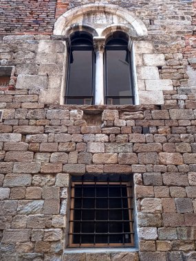 Facade of the old medieval house in Pisa 