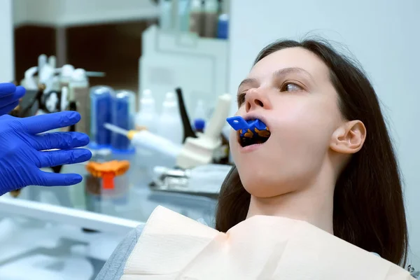 치과에서 위턱에 여자가 의족을 만들려고 합니다 치과에서 의사의 보조제의 자판기를 — 스톡 사진
