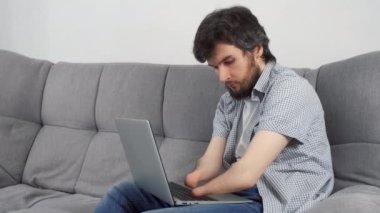 Özürlü bir adam, sakat ve iki kolu kesilmiş. Ev bilgisayarında, koltukta oturmuş daktilo yazıyor. Engelli insanlara uyum sorunu. Bağımsız Bağımsız kişi.