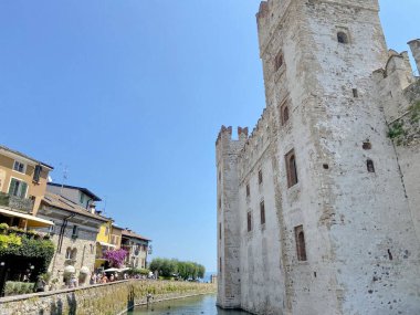 The unsurpassed beauty of the amazingly strong towers of the Scaliger Castle through the prism of the summer sun. clipart