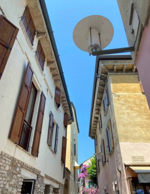 A pleasant walk through the quiet narrow streets of an Italian town under the shadow of the ancient buildings surrounding them. clipart