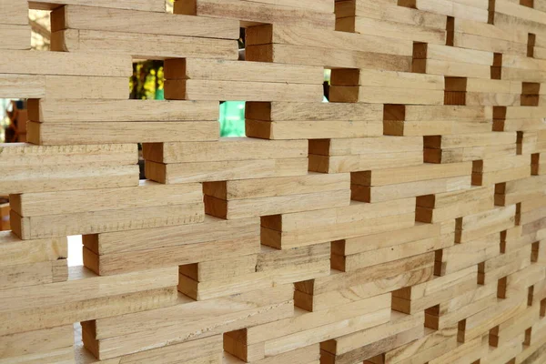 Wood wall made from small piece of timber, small square shape hole on broad.Beside perspective view of light brown wood and space background.