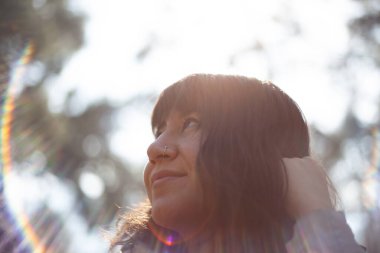 Portrait of young woman in sunbeams