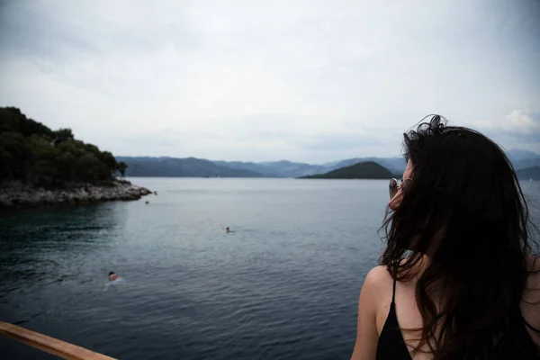 Portrait of beautiful woman relaxing and looking at view on ferry