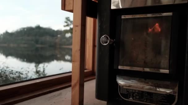 Fire Burns Sauna Stove Panoramic Windows Sill Lake High Quality — Vídeo de Stock