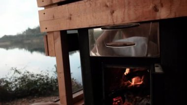 Heating up sauna stove. Finnish traditional sauna with panoramic windows. High quality 4k footage