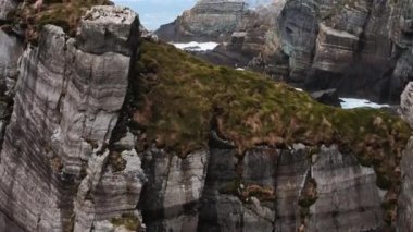Drone flying through Island cliffs in Ireland, Aerial view near of Mizen Head. High quality 4k footage