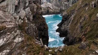 Drone flying through Island cliffs in Ireland, Aerial view near of Mizen Head. High quality 4k footage