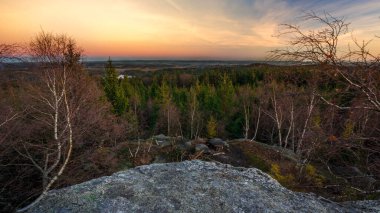 Evening on rock with view to countryside