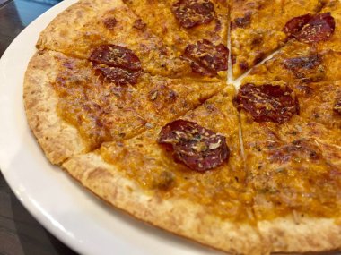 A classic Italian cheese pizza served on a white plate