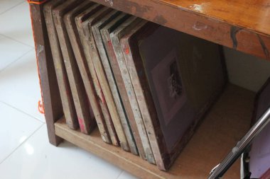 Screen printing boards neatly arranged in the cupboard