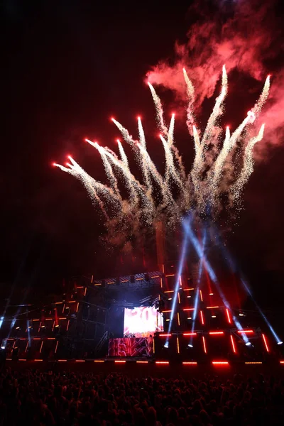 stock image salute and fireworks on a music stage with spotlights at night