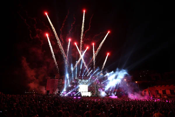 Stock image salute and fireworks on a music stage with spotlights at night