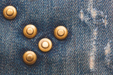 close-up of metal button, rivets on denim texture