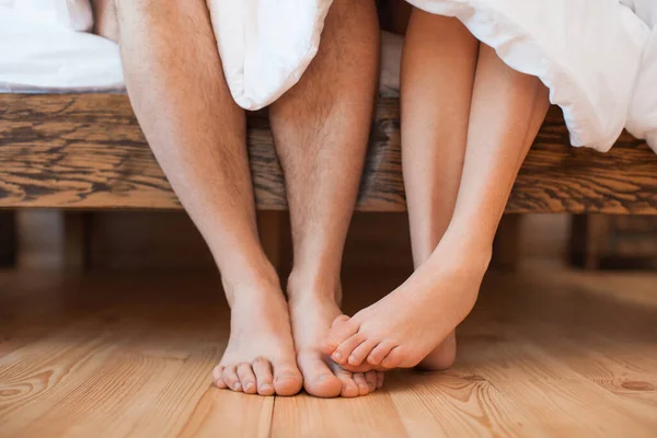 young couple in love making love, close-up of bare legs