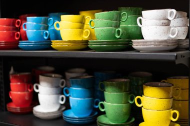 a lot of colored cup on the shelf 