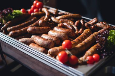 delicious grilled sausages with salad and vegetables