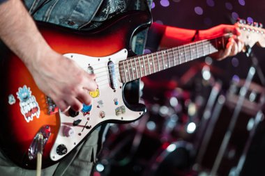close up play electric guitar at a rock concert