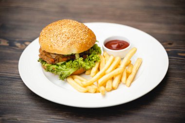 menu with delicious juicy burger and fries with sauce on a plate