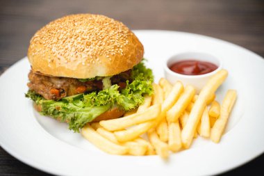 menu with delicious juicy burger and fries with sauce on a plate