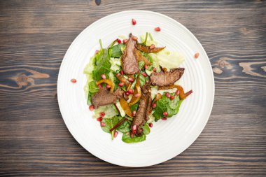 tasty and fresh meat salad on a plate in a restaurant from a chef