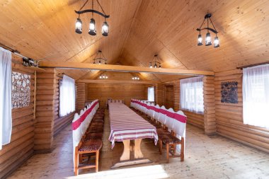 The interior of the restaurant in the style of wood, with a large table and chairs