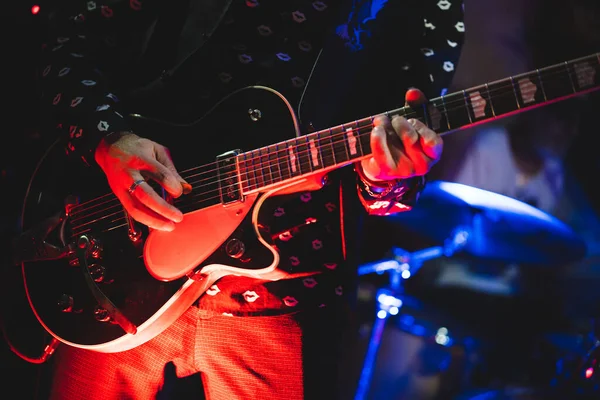 close up play electric guitar at a rock concert