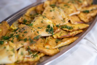 delicious triangular pancakes with greens laid out on a plate