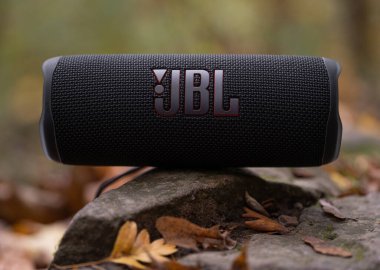 LVIV, UKRAINE - OCTOBER 12, 2022: JBL Flip 6 Black, portable bluetooth speaker outdoors in the autumn letter