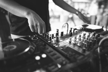 a DJ plays music on a controller at a party