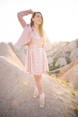 a beautiful girl walks on the top of the mountain enjoying the view