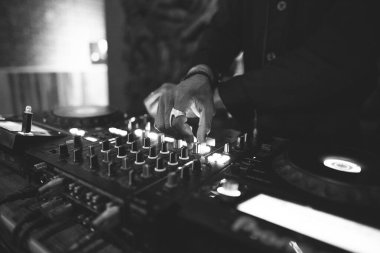 a DJ plays music on a controller at a party